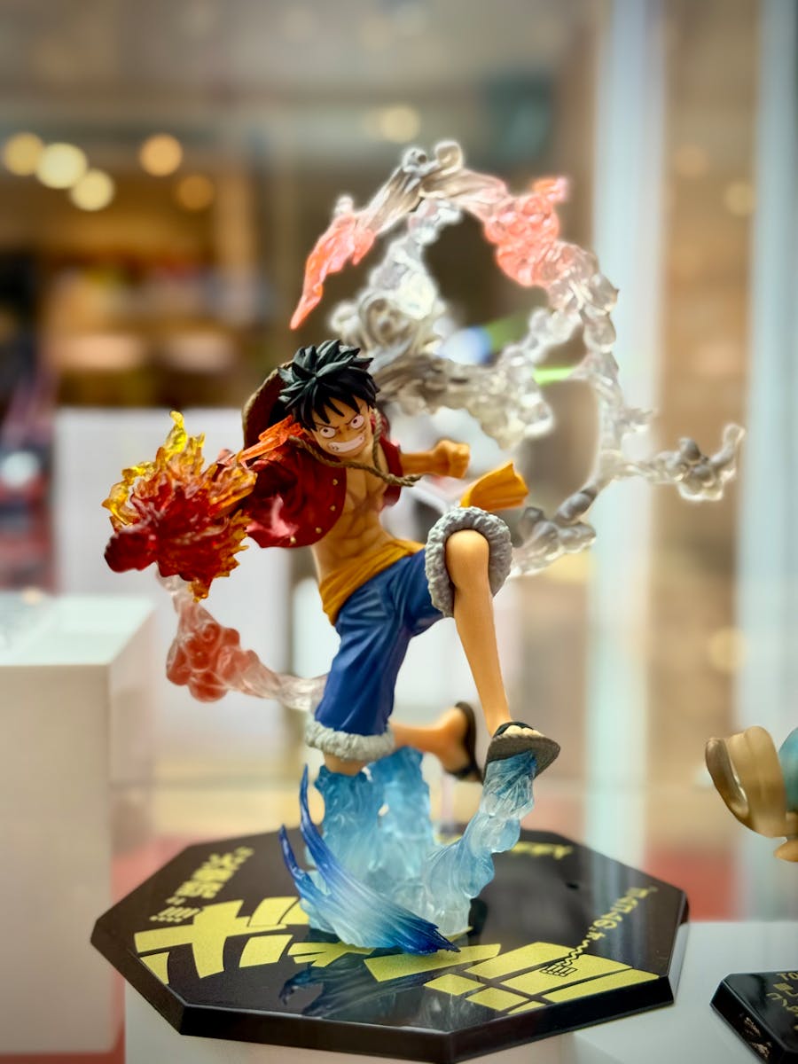 Vivid anime action figure depicting dynamic motion and fiery special effects in a display case.